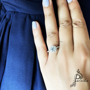 silver ring on finger with one Solitaire
